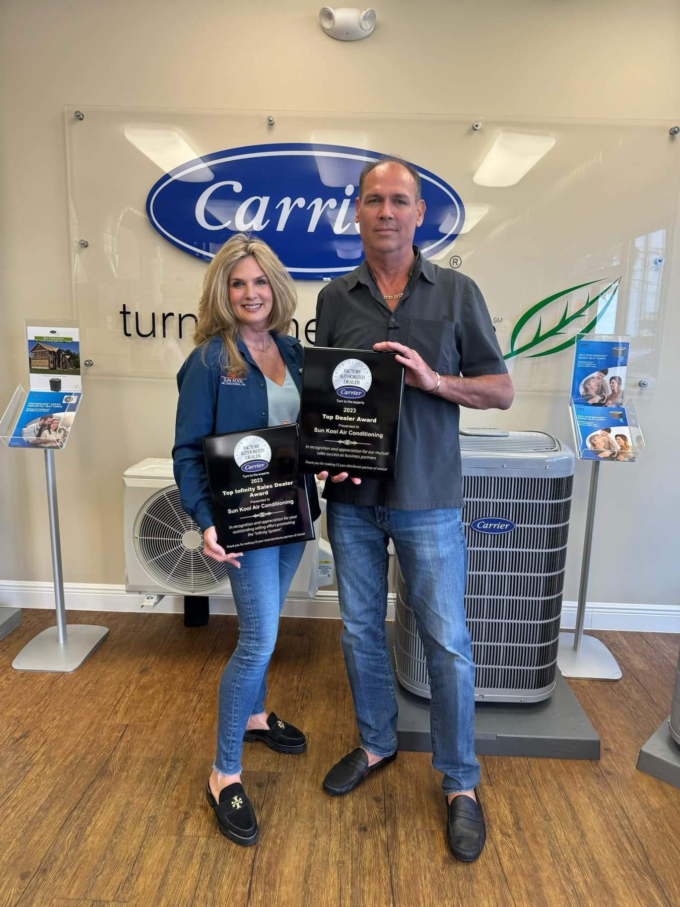 employees holding plaques